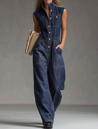 Dark blue denim sleeveless balloon jumpsuit with multiple pockets for women, featuring a relaxed fit and stylish design.