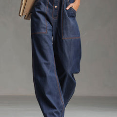 Dark blue denim women’s sleeveless balloon jumpsuit with multiple pockets, featuring a relaxed fit and stylish design.