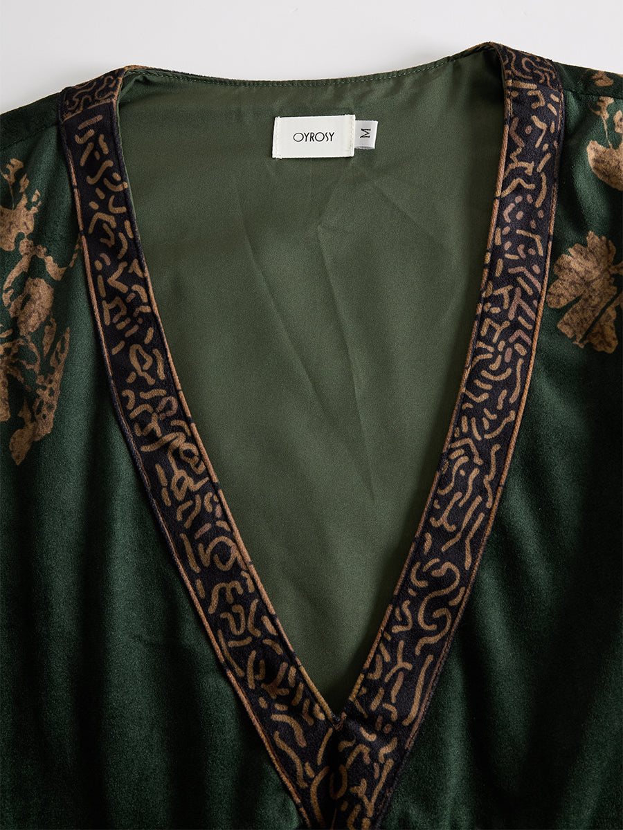 Green faux suede tassel maxi dress for women by Christine Brewer, featuring a flowing silhouette and stylish tassel details.