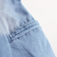 Light blue denim sleeveless wide-leg jumpsuit with raw edges, designed for women by Christine Brewer, shown on model.