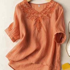 Light beige V-neck linen summer blouse for women with a flowy, casual fit, by Christine Brewer, showing front view.