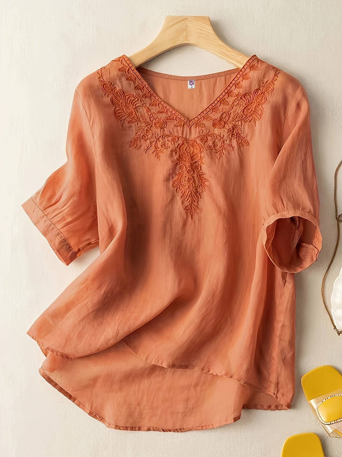 Light beige V-neck linen summer blouse for women with a flowy, casual fit, by Christine Brewer, showing front view.