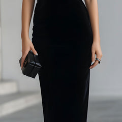 Black velvet bow midi dress for women by Christine Brewer, featuring a fitted silhouette and elegant bow detail at the waist.