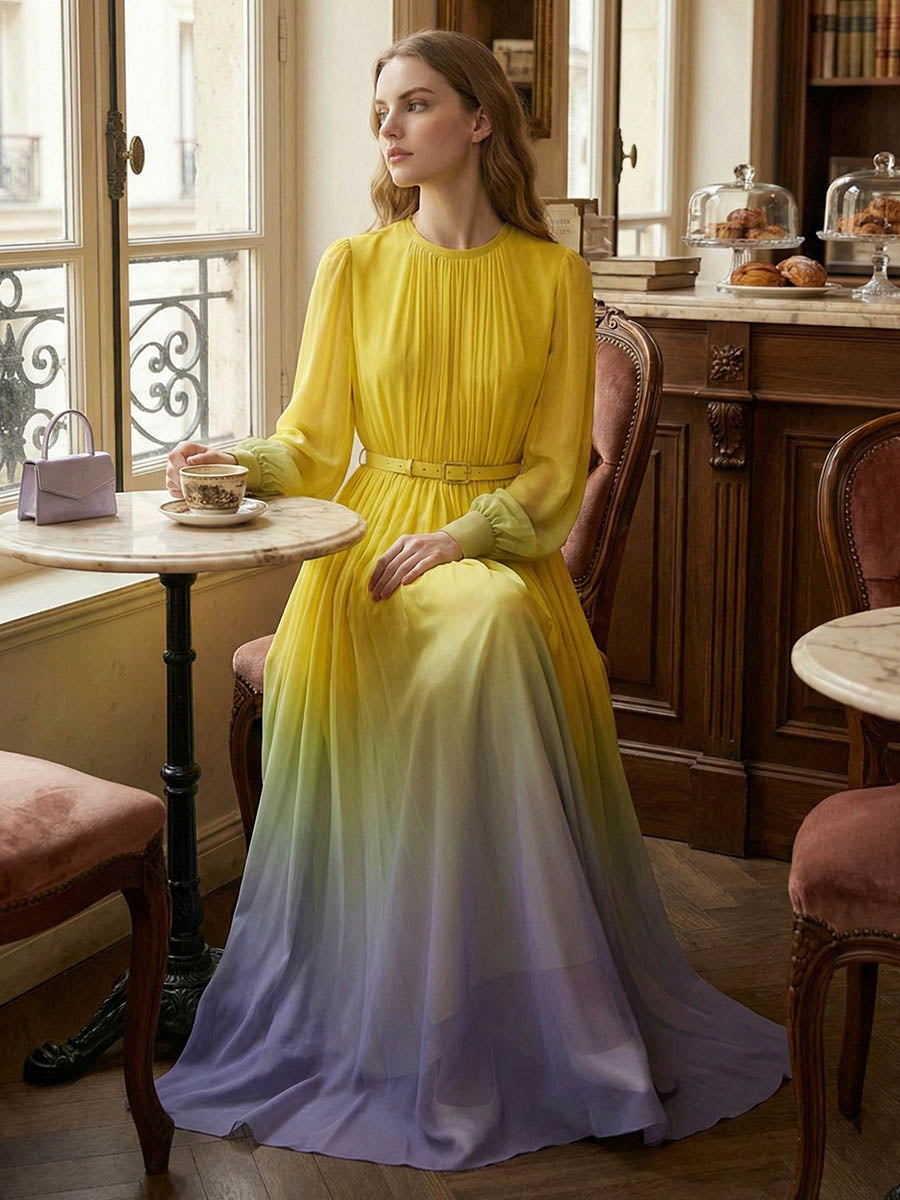 Long sleeved high waisted maxi dress by Christine Brewer featuring contrast color gradient, pleated design, belt, and split-joint round neck.