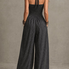 Charcoal pinstripe halter neck wide-leg jumpsuit for women by Christine Brewer, featuring a stylish halter top and flowing wide-leg pants.
