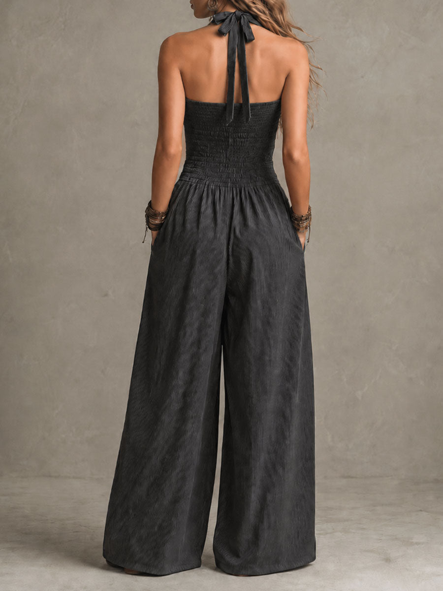 Charcoal pinstripe halter neck wide-leg jumpsuit for women by Christine Brewer, featuring a stylish halter top and flowing wide-leg pants.