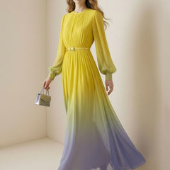 Christine Brewer high waisted maxi dress with long sleeves, belt, contrast color gradient, pleated design, and round neck.