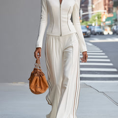 White stand collar zip-up wide-leg women's trouser suit by Christine Brewer, featuring tailored pants and a stylish collar detail.