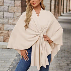 Christine Brewer Cecilia knit poncho for women, stylish and cozy top with a draped, textured fabric in neutral tones.