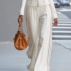 White stand collar zip-up wide-leg pants suit for women by Christine Brewer, featuring tailored trousers and a matching top.