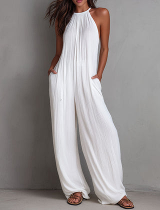 White pleated halter neck wide-leg resort jumpsuit for women by Christine Brewer, featuring stylish pleats and a halter neckline.