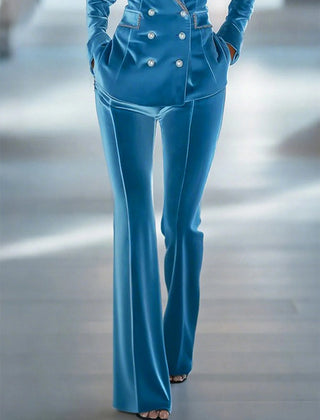 Blue loose velvet flared trousers for women by Christine Brewer, showing the relaxed fit and stylish flare detail.