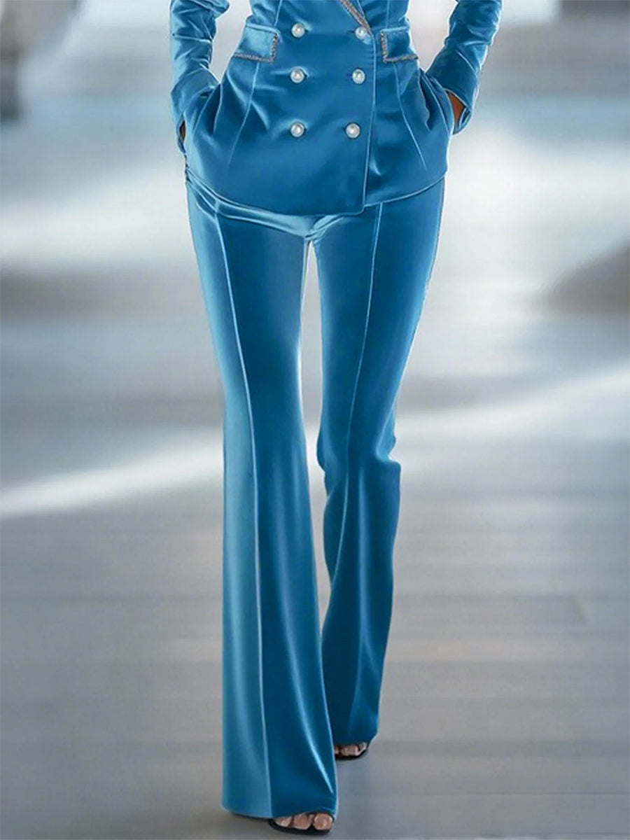 Blue loose velvet flared trousers for women by Christine Brewer, showing the relaxed fit and stylish flare detail.