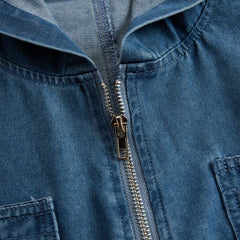 Women’s casual loose retro denim jumpsuit with long sleeves, hood, zipper, and pockets by Christine Brewer, styled as pants.