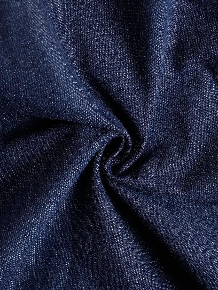 Dark blue denim sleeveless balloon jumpsuit with multiple pockets for women, by Christine Brewer, shown on a model.