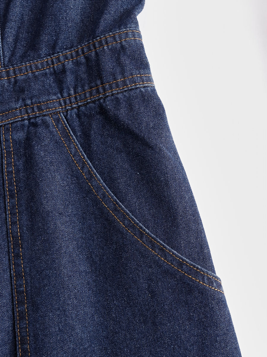 Dark blue denim sleeveless balloon jumpsuit with multiple pockets, designed for women by Christine Brewer.