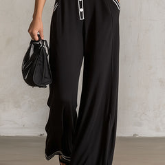 Black color-block V-neck sleeveless jumpsuit with button-down front and tailored pants style by Christine Brewer.