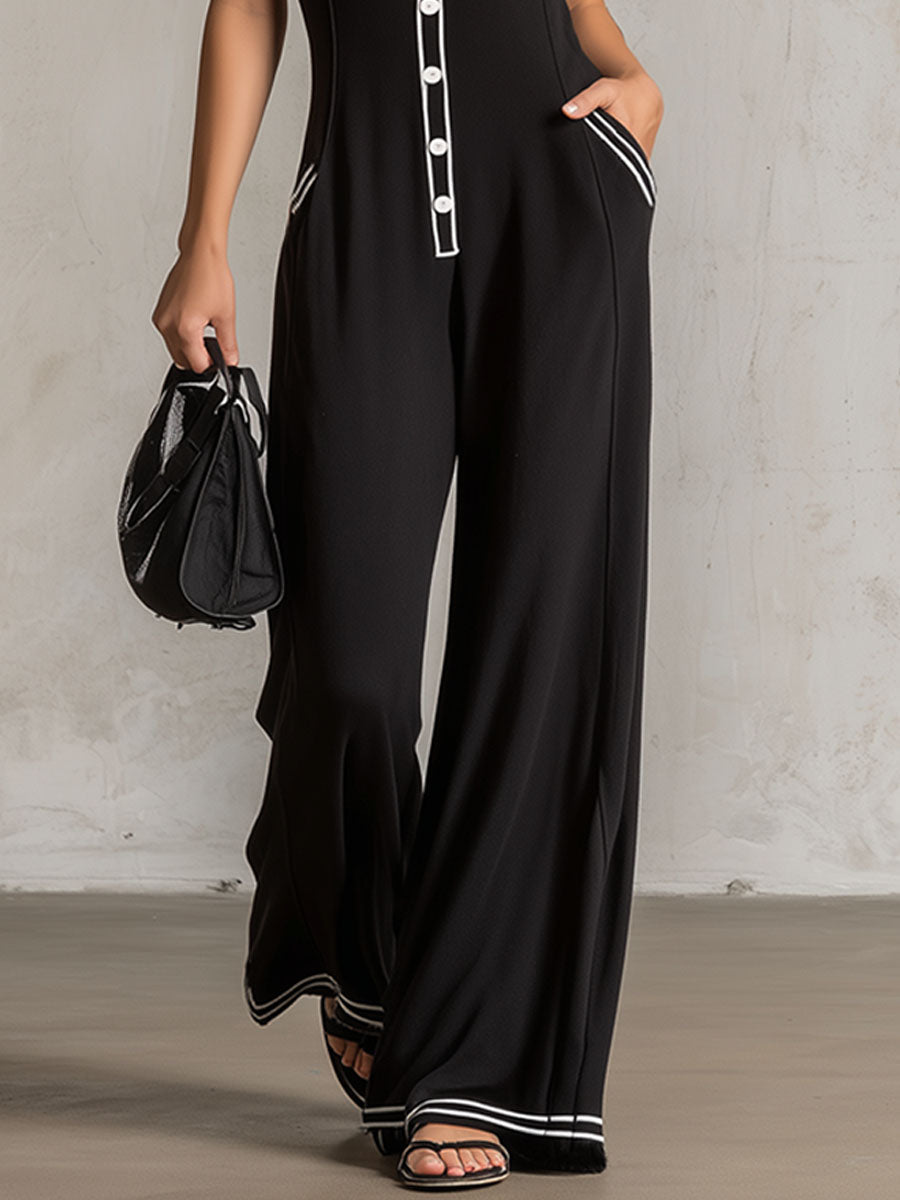 Black color-block V-neck sleeveless jumpsuit with button-down front and tailored pants style by Christine Brewer.