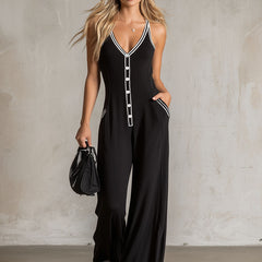 Black color-block V-neck sleeveless jumpsuit by Christine Brewer featuring button-down front and tapered pants for women.
