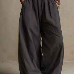 Charcoal pinstripe halter neck wide-leg jumpsuit for women by Christine Brewer, featuring a stylish halter top and flowing wide-leg pants.