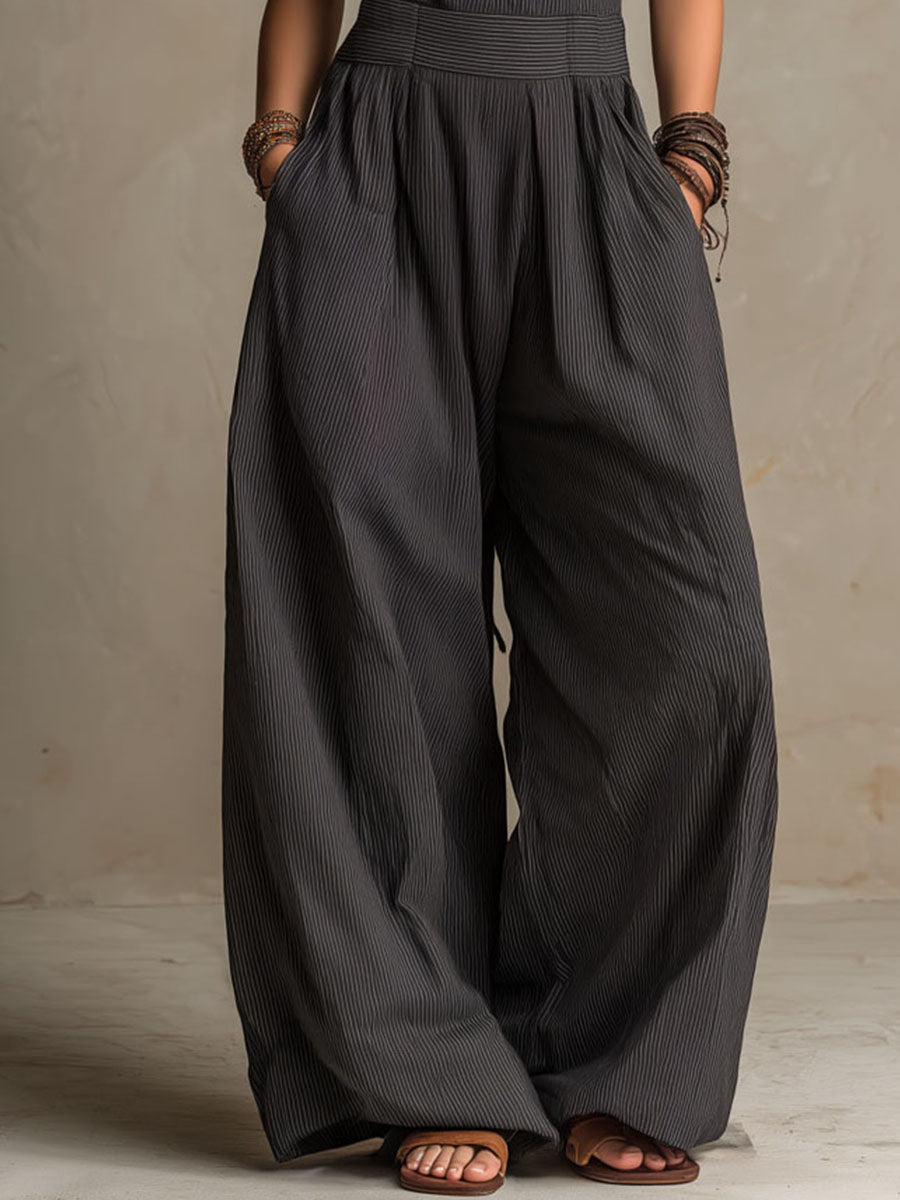 Charcoal pinstripe halter neck wide-leg jumpsuit for women by Christine Brewer, featuring a stylish halter top and flowing wide-leg pants.