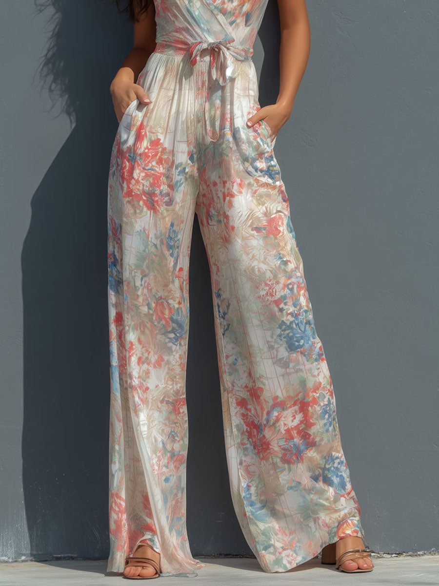 White floral satin halter neck jumpsuit with wide-leg pants for women by Christine Brewer, featuring wrap front design.