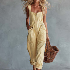 Light yellow denim jumpsuit for women with square neck and zip-front, by Christine Brewer, featuring stylish pant design.