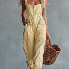 Light yellow denim jumpsuit with square neckline and zip-front closure, women's pants by Christine Brewer, styled with a fitted silhouette.