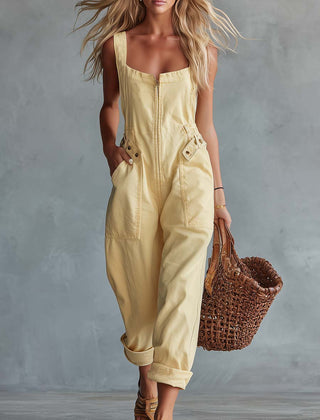 Light yellow denim jumpsuit with square neckline and zip-front closure, women's pants by Christine Brewer, styled with a fitted silhouette.