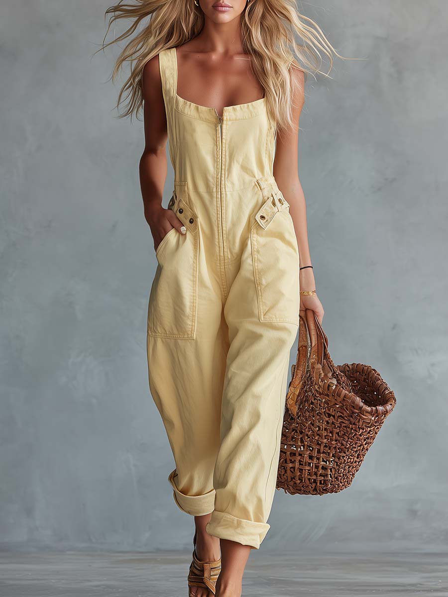 Light yellow denim jumpsuit with square neckline and zip-front closure, women's pants by Christine Brewer, styled with a fitted silhouette.