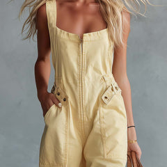 Light yellow denim jumpsuit for women with square neckline and zip-front closure, by Christine Brewer.