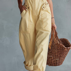 Light yellow denim jumpsuit for women with square neckline and zip-front, by Christine Brewer, featuring stylish pant silhouette.