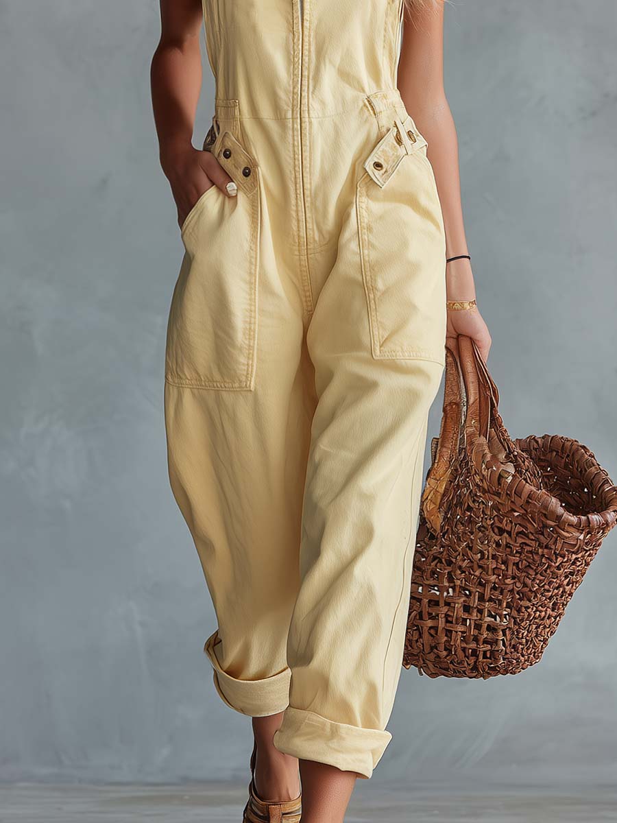 Light yellow denim jumpsuit for women with square neckline and zip-front, by Christine Brewer, featuring stylish pant silhouette.