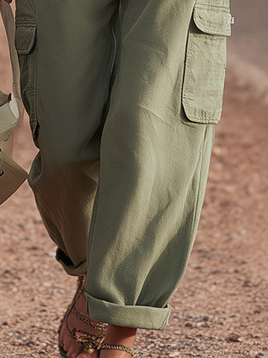 Green multi-pocket cargo trousers for women by Christine Brewer, featuring multiple functional pockets and a relaxed fit.