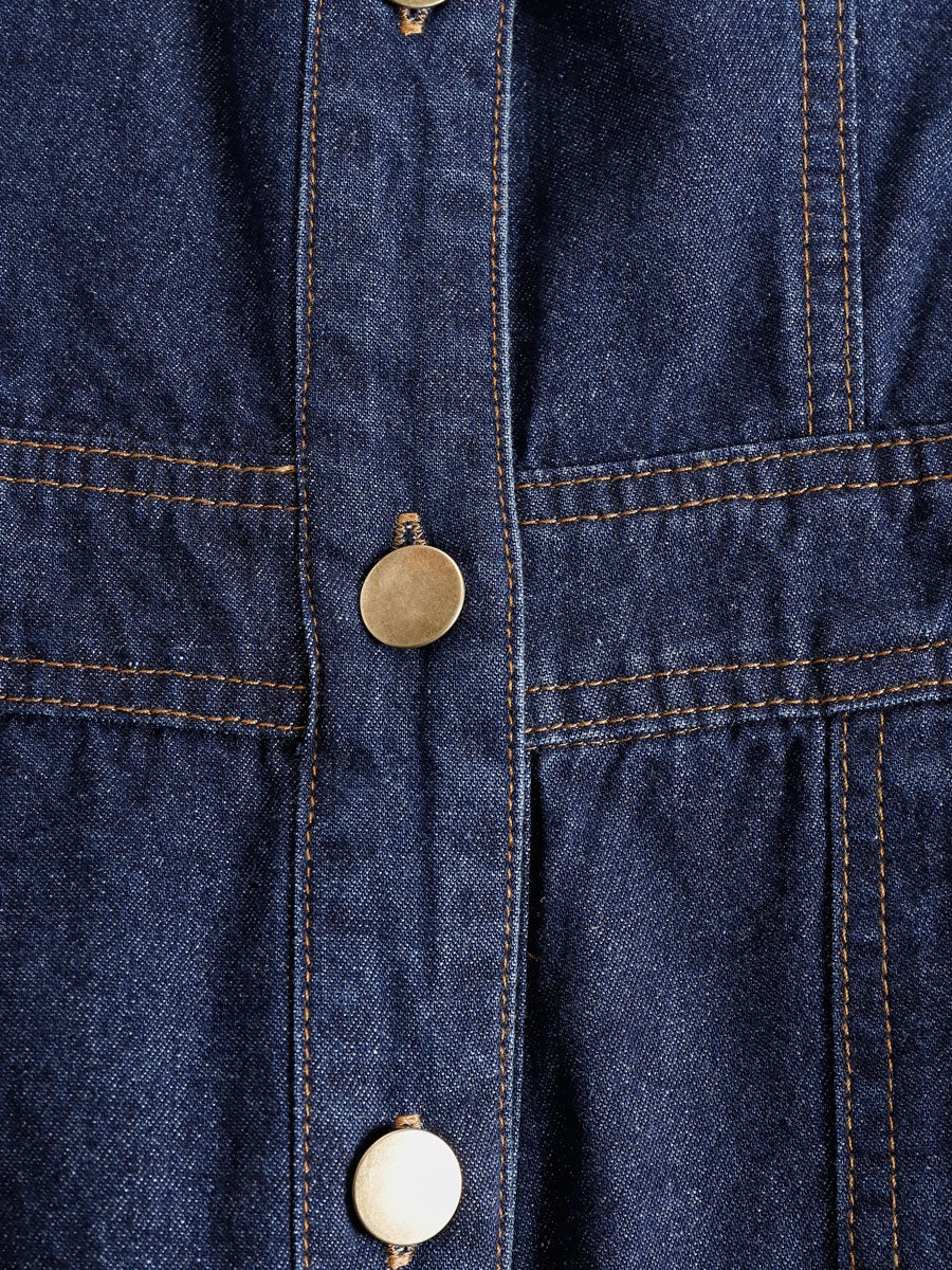 Dark blue denim sleeveless balloon jumpsuit with multi-pocket design for women, featuring a relaxed fit and stylish details.