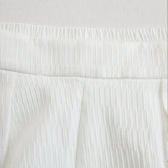 Cream textured lantern sleeve two-piece set with pants for women by Christine Brewer, shown on a model.