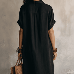 Black linen relaxed midi dress for women by Christine Brewer, featuring a flowy silhouette and casual style.