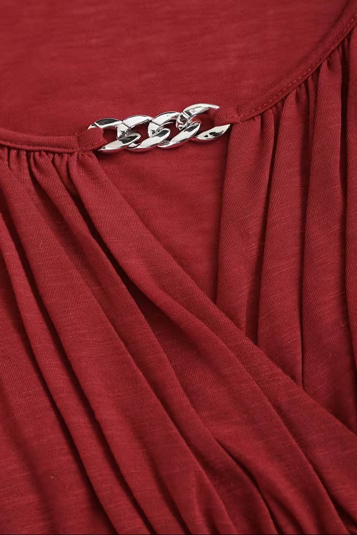 Olivia V-neck top for women by Christine Brewer, featuring a fitted design and soft fabric, shown in a stylish casual setting.