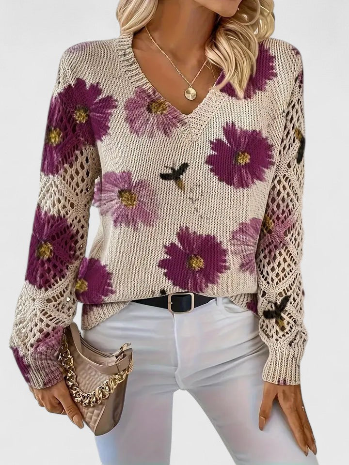 Women’s floral V-neck cardigan by Christine Brewer featuring a soft, colorful floral pattern and a relaxed fit.