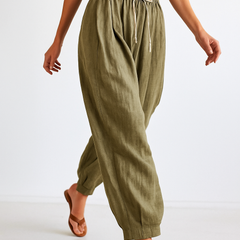 Loose tapered linen trousers for women by Christine Brewer, featuring a relaxed pull-on style and lightweight fabric.