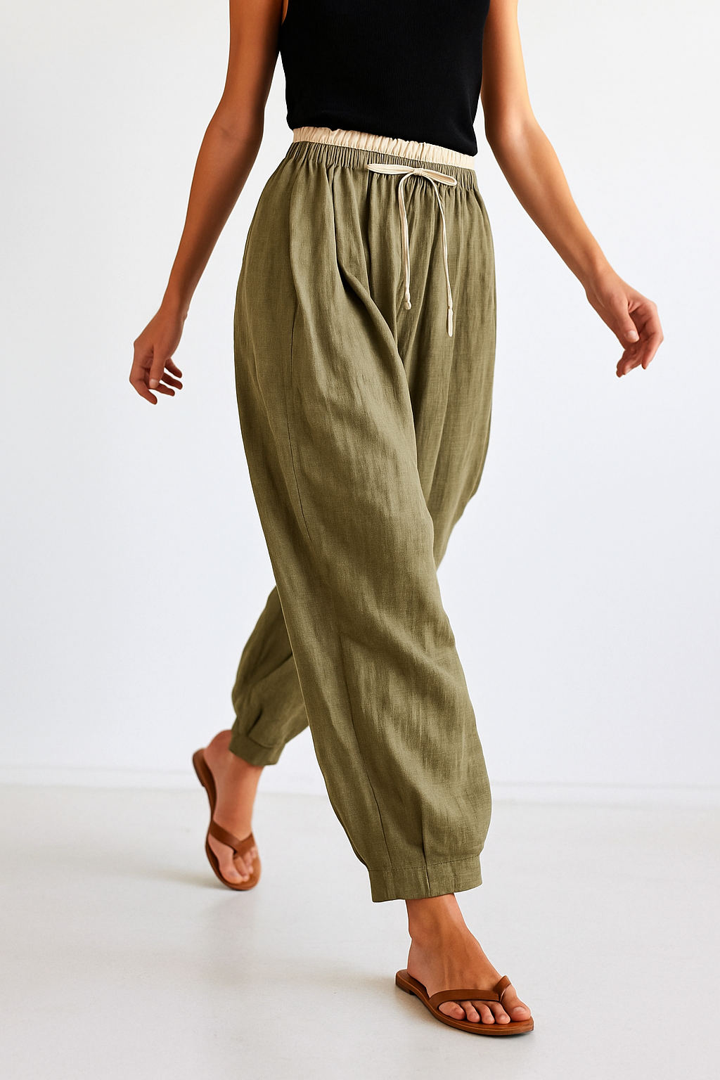 Loose tapered linen trousers for women by Christine Brewer, featuring a relaxed pull-on style and lightweight fabric.