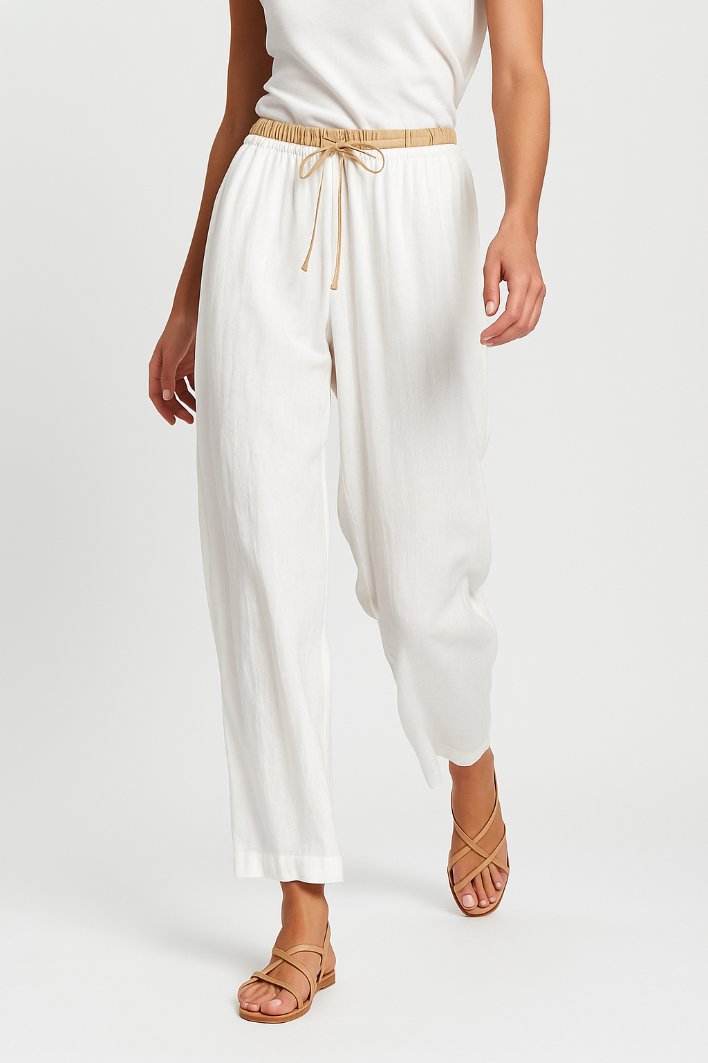 Loose tapered linen trousers for women by Christine Brewer, showcasing comfortable pull-on design and relaxed fit.