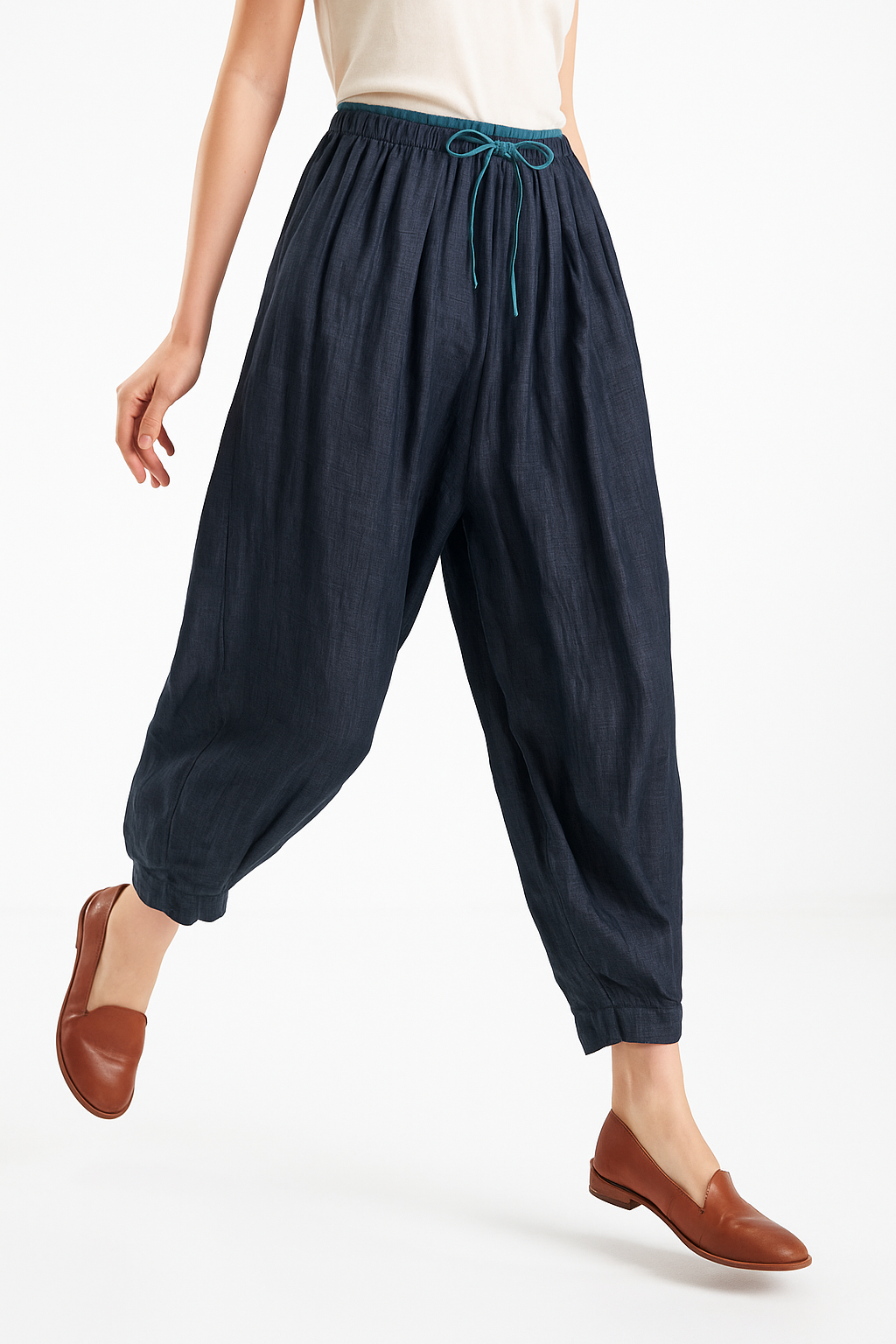 Tapered linen trousers for women by Christine Brewer, loose pull-on style, displayed on a white background.