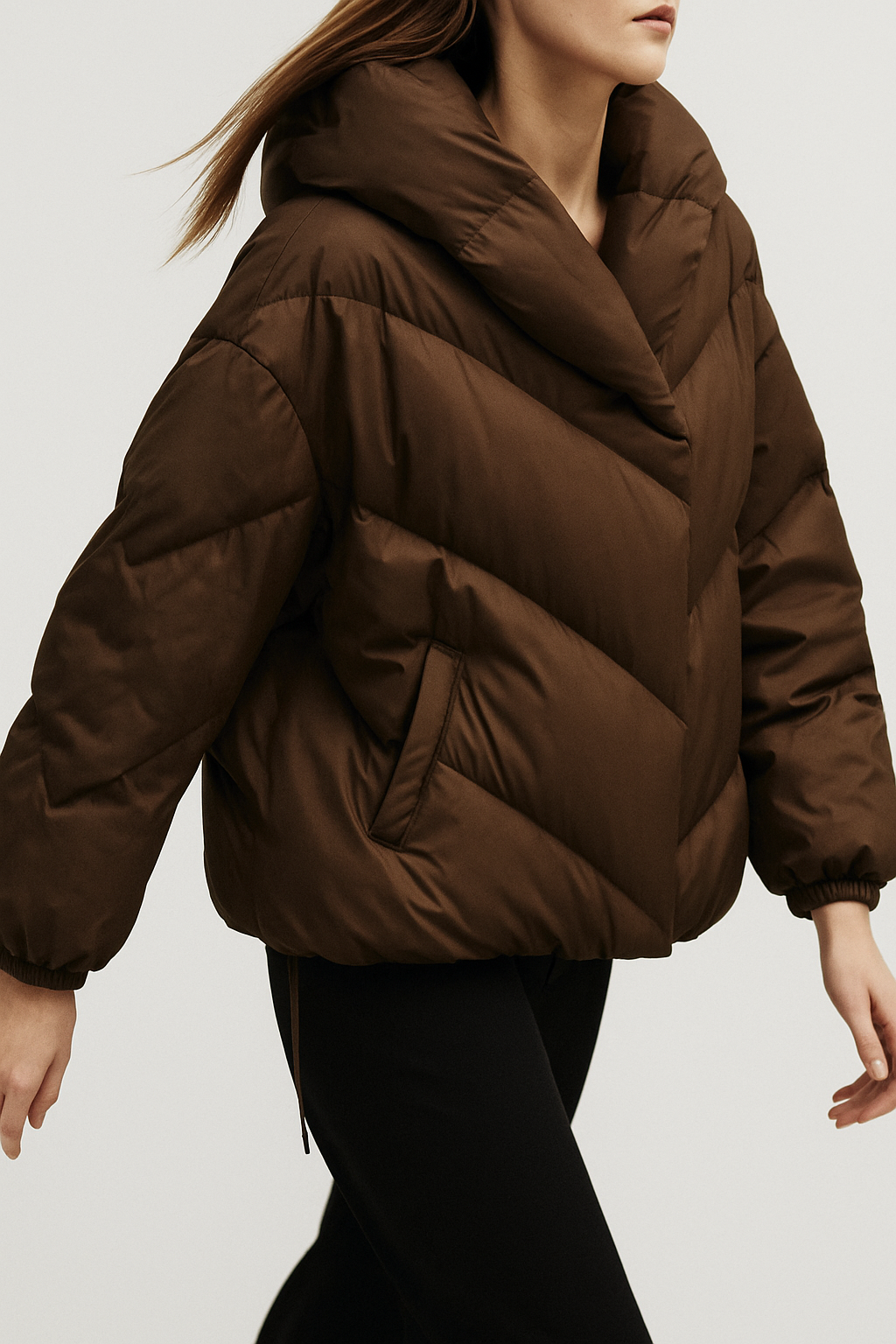 Brown cropped hooded puffer jacket for women by Christine Brewer, showcasing the lightweight, quilted design and hood detail.