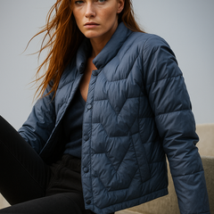 Blue Aurora short quilted puffer jacket for women by Christine Brewer, featuring a stylish, padded design with a stand-up collar.