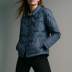 Blue Aurora short quilted puffer jacket for women by Christine Brewer, featuring a stylish, insulated design with a high collar.