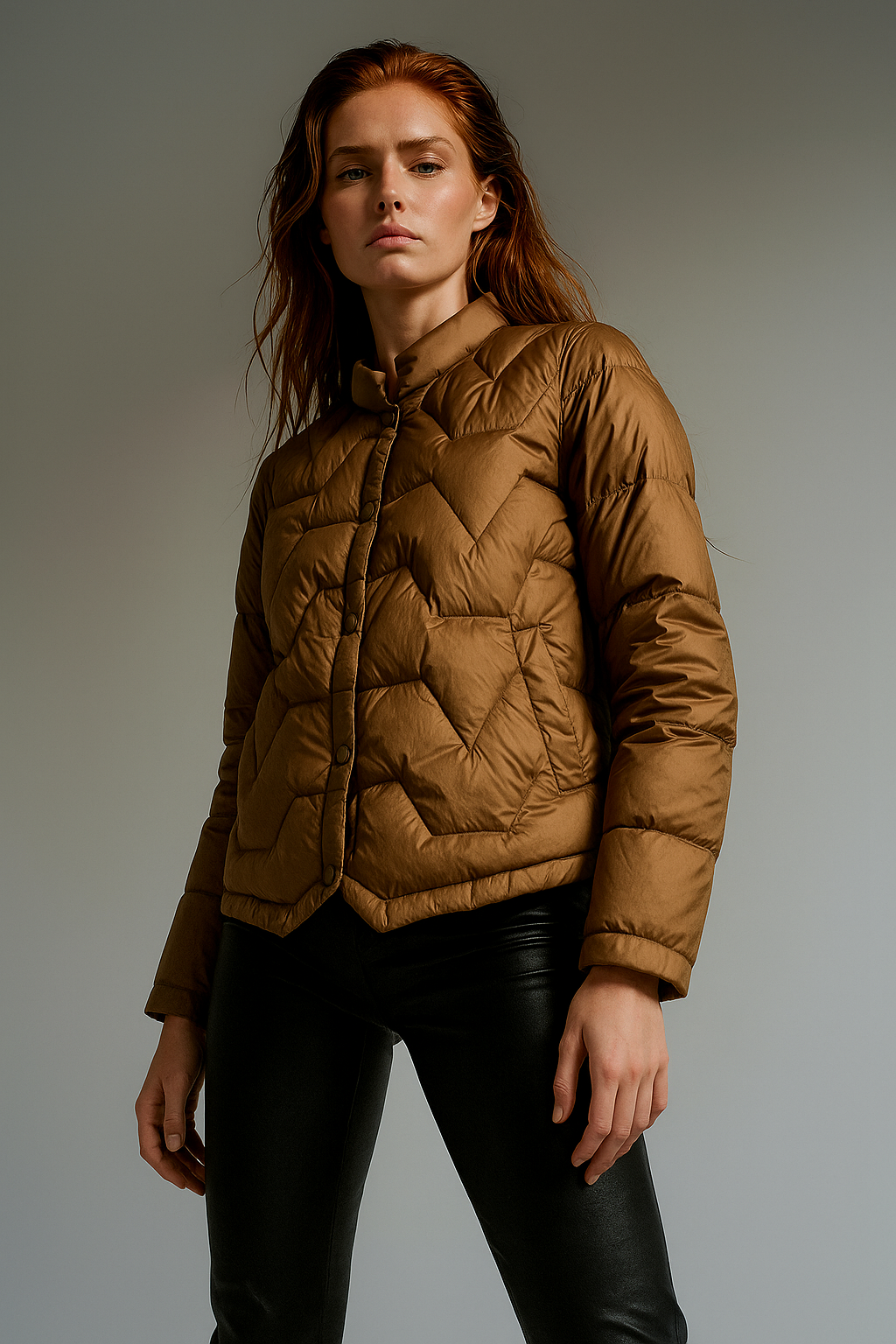 Brown quilted puffer jacket for women by Christine Brewer, featuring short design and quilted texture.