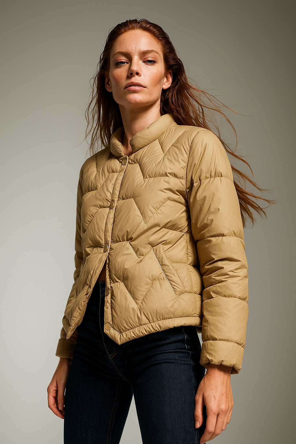 Beige Aurora short quilted puffer jacket for women by Christine Brewer, showing the puffed design and collar detail.