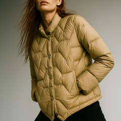 Beige Aurora short quilted puffer jacket for women by Christine Brewer, featuring a stylish, insulated design with a stand collar.