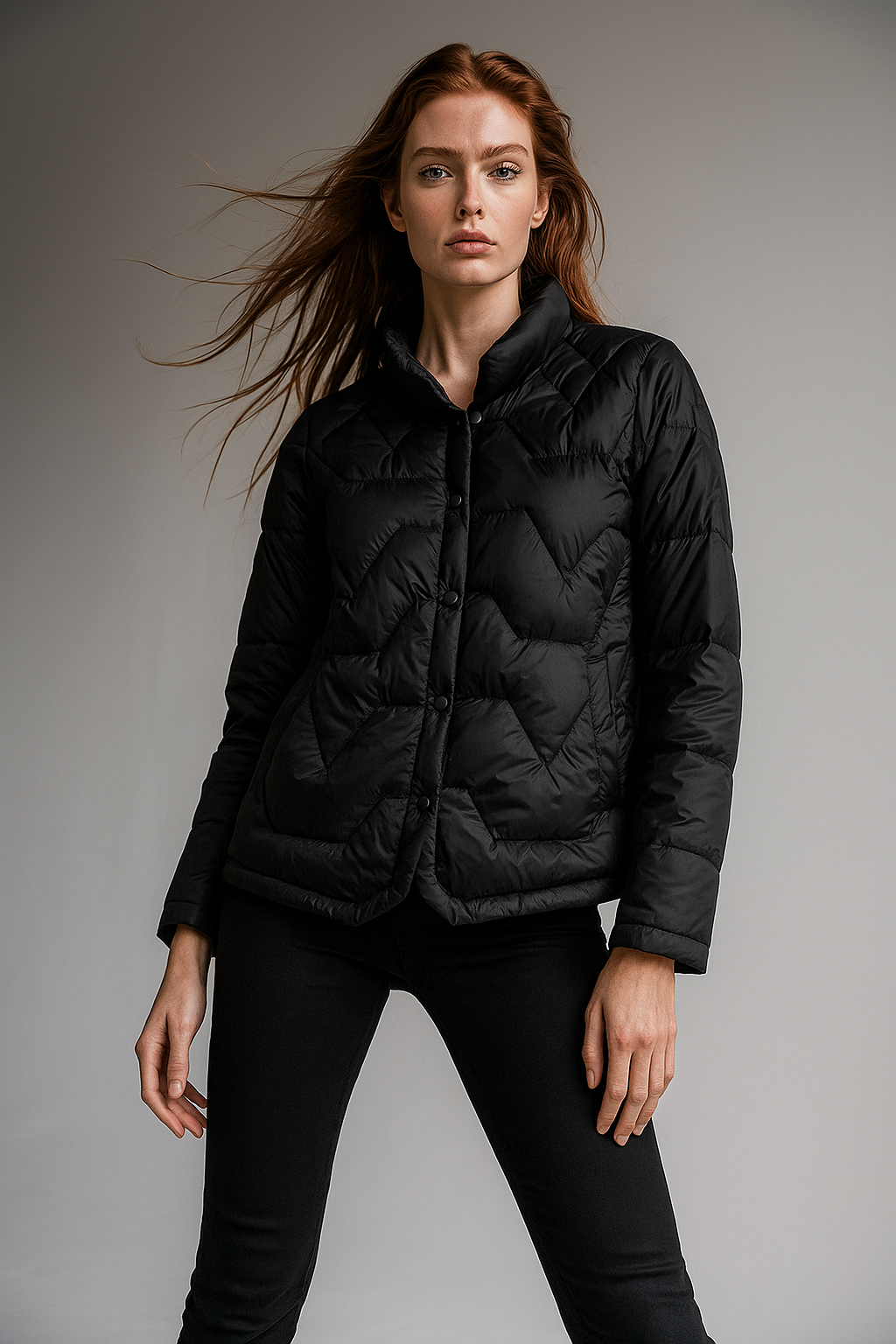 Black Aurora short quilted puffer jacket for women by Christine Brewer, featuring a sleek, padded design and stand-up collar.